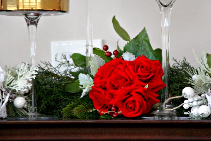 The bride chose gold and cranberry as her color palette. The red bouquet of flowers looked beautiful among the garland. The bride chose gold and cranberry as her color palette. The red bouquet of flowers looked beautiful among the garland.
