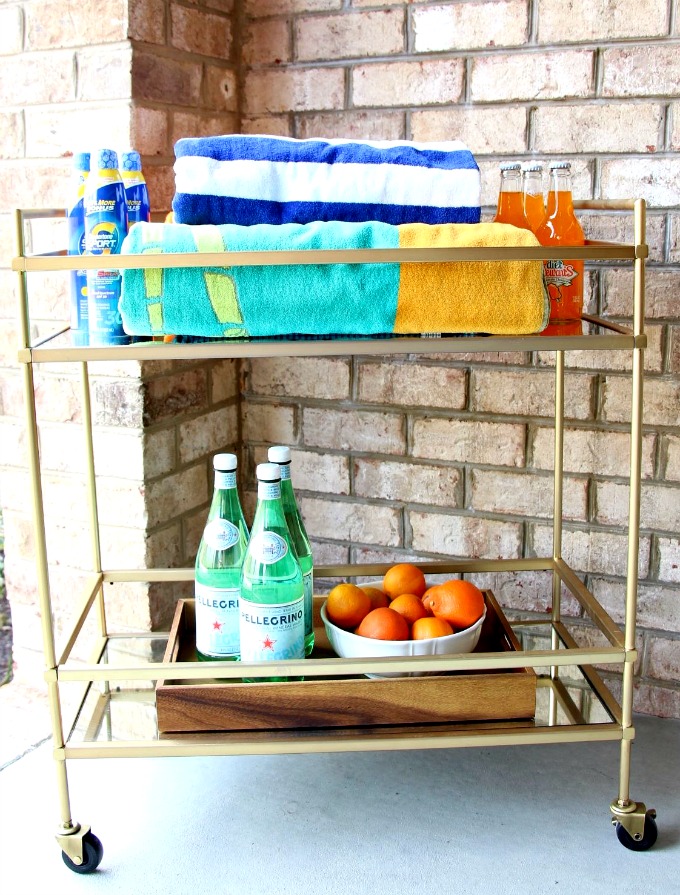 Using the bar cart for outdoor entertaining is a great way to keep all your essentials in one place. www.jennelyinteriors.com